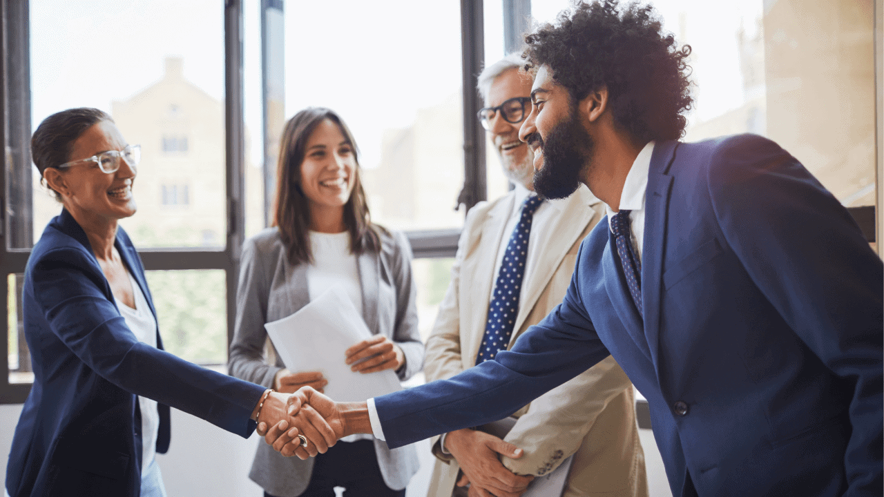 Business students and educators shaking hands and greeting each other
