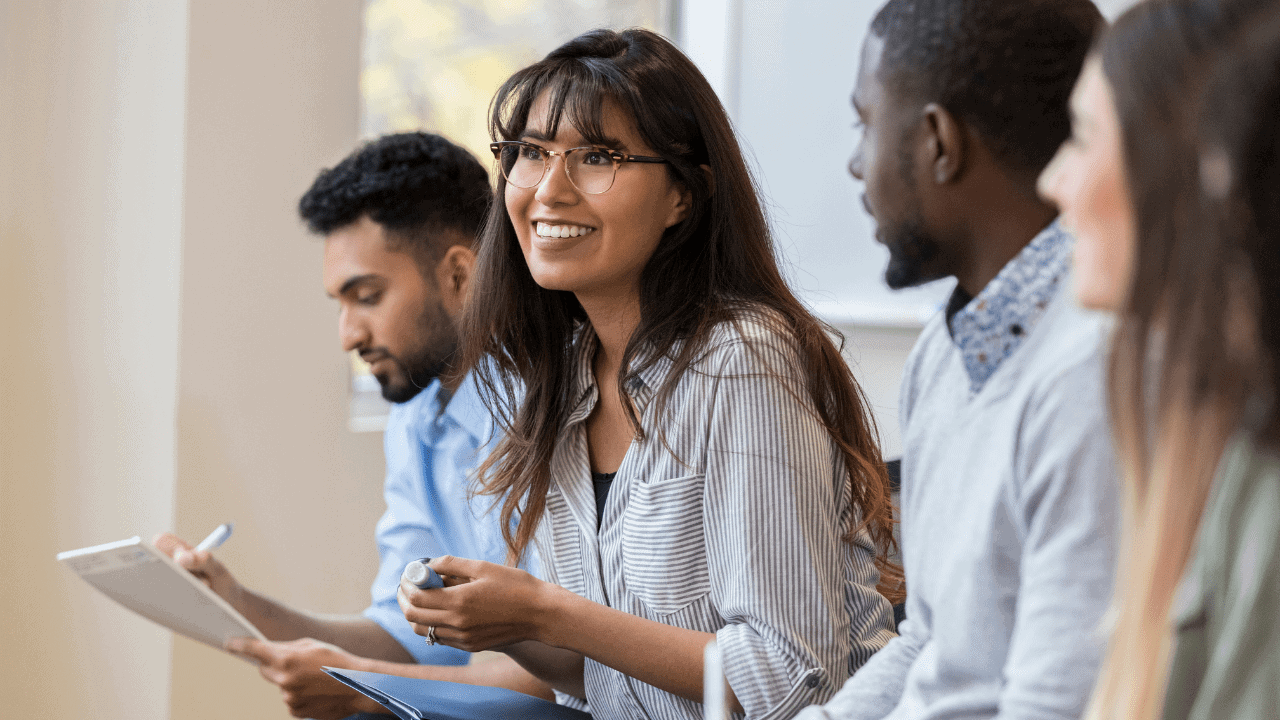 Four diverse students in a classroom setting