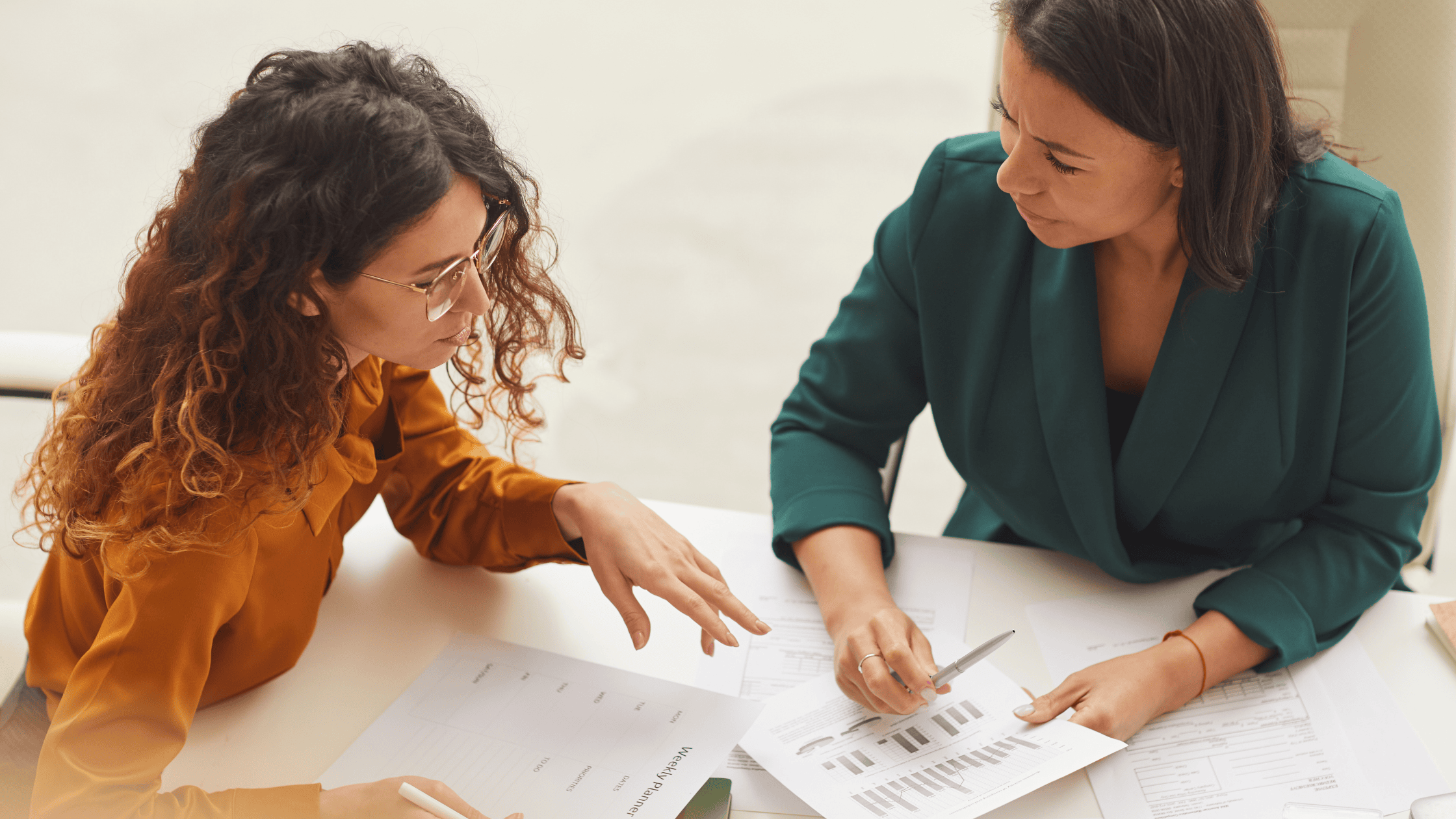 Mentor and mentee work together at a table.