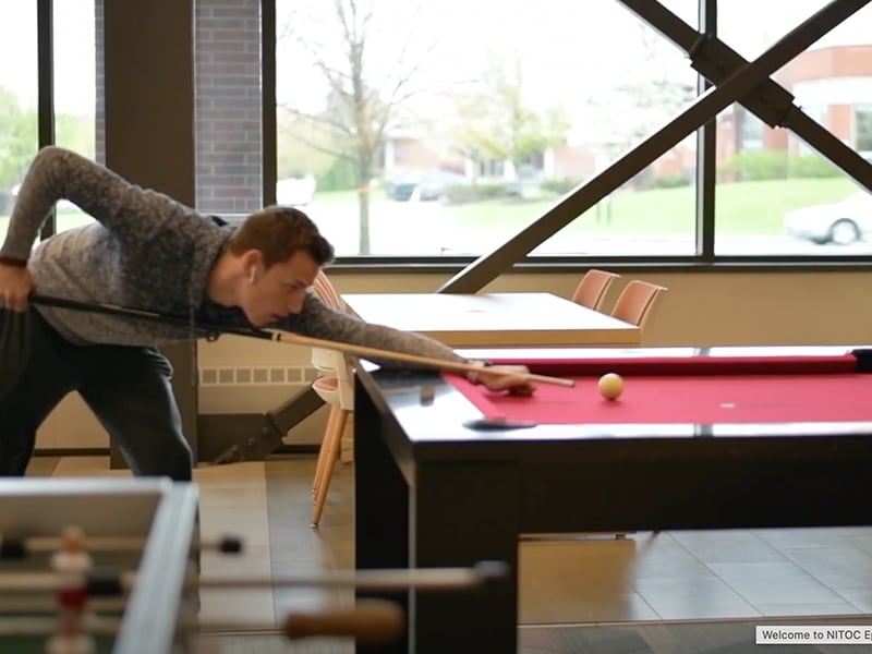 Roberts Weselyan University student playing billiards