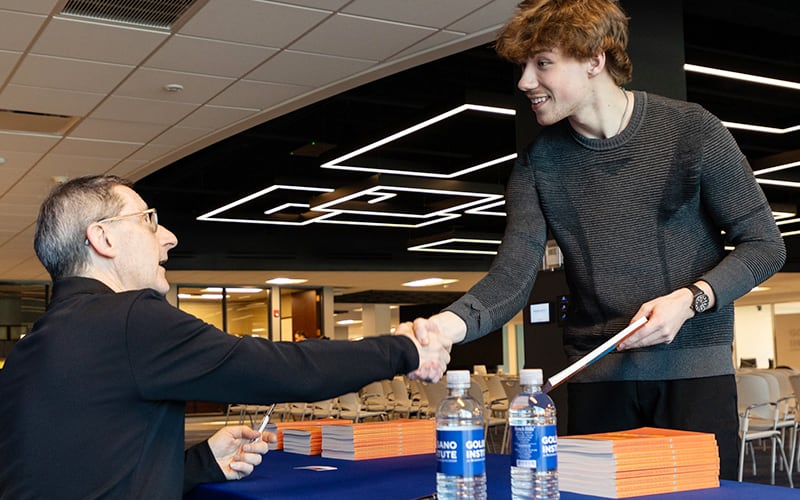 Student shaking hands with Speaking from Experience speaker