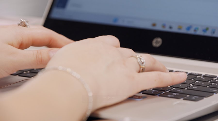Woman typing on keyboard.