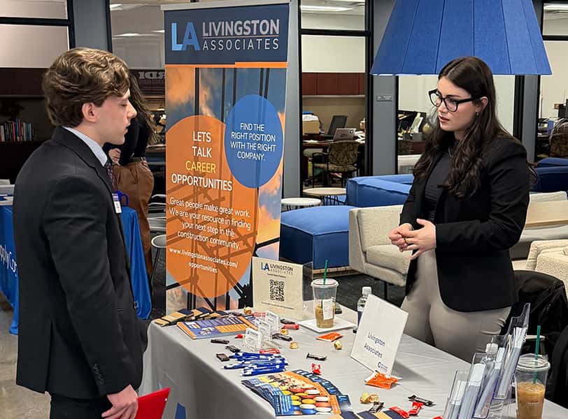 Student speaking with company at a hiring event.