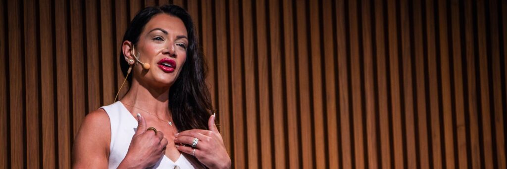 Shaina Zazzaro presenting on stage at Speaking from Experience.