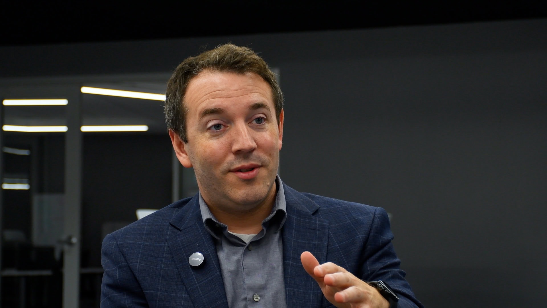 A male in his early 40s responds to an interviewer off camera asking about AI and business education.