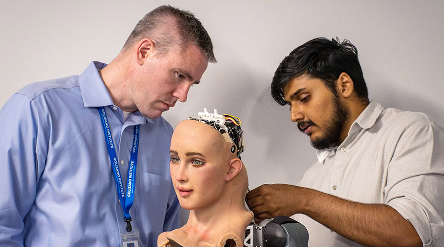 Two men working on an AI powered robot humanoid.