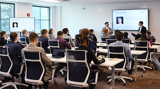 A group of students listening to a presentation.
