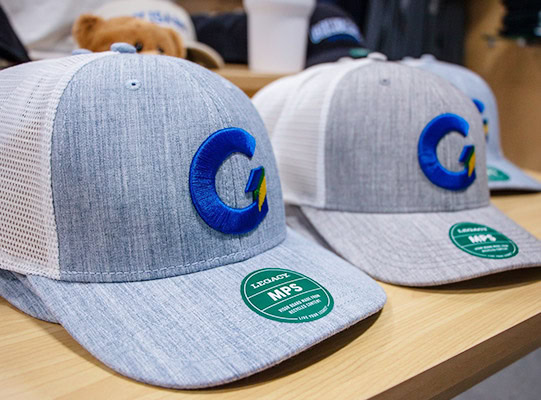 Golisano Institute baseball caps on sale at the Exchange campus store.