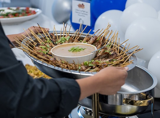 A tray of appetizers being held.