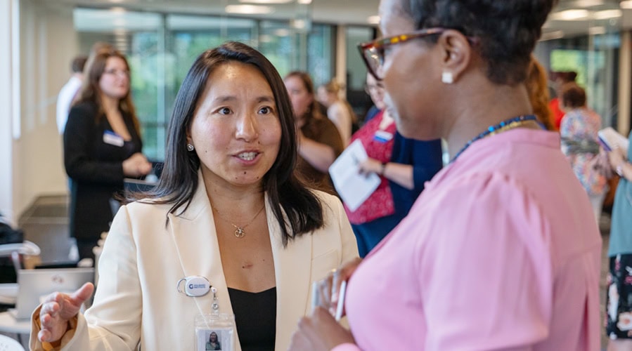 Student and staff member in conversation.
