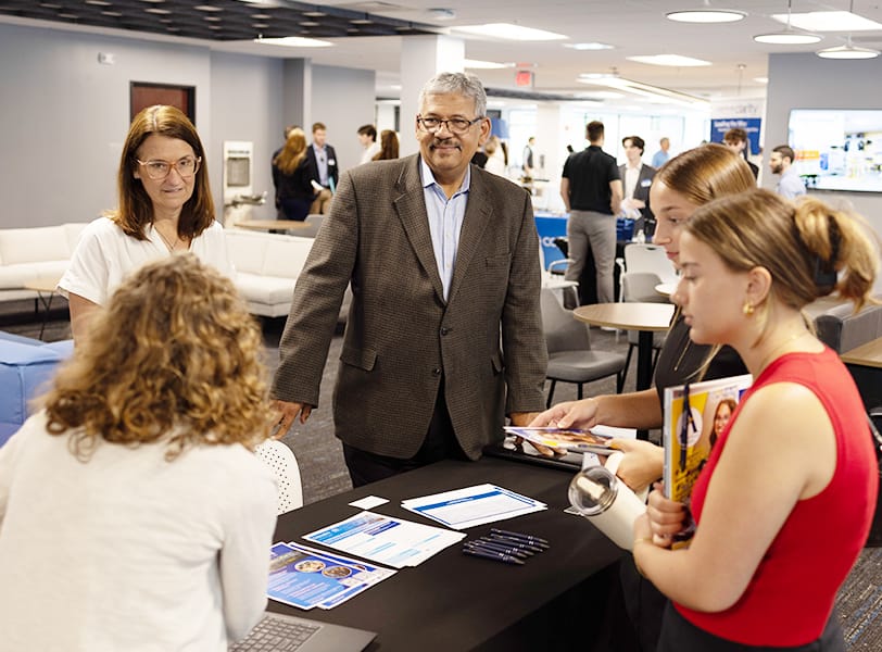 A career fair at Golisano Institute with two business leaders speaking to students.