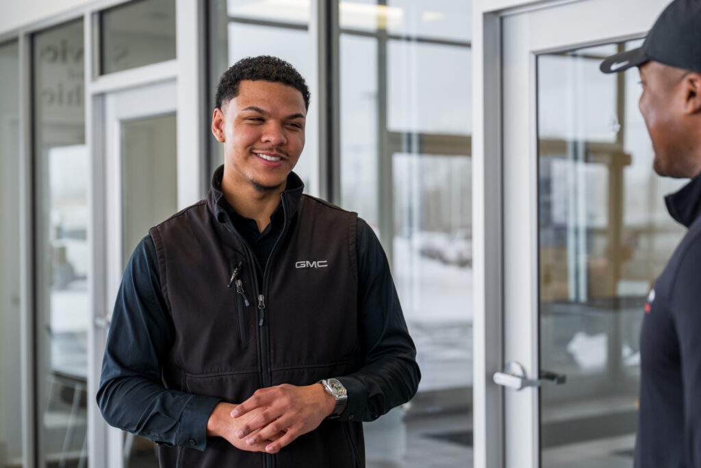 Alumni Jordan Kujawski poses for photos at Bob Johnson Buick GMC in Rochester, N.Y. on February 12, 2026.