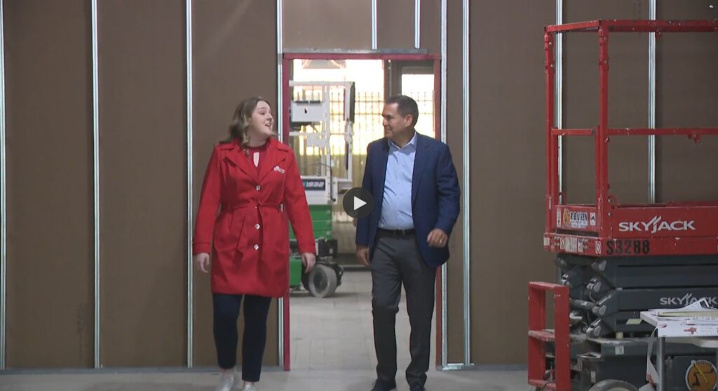 A reporter walks with Jim Dentinger, executive vice president & Buffalo regional director, through Golisano Institute's Buffalo campus center as it undergoes construction.