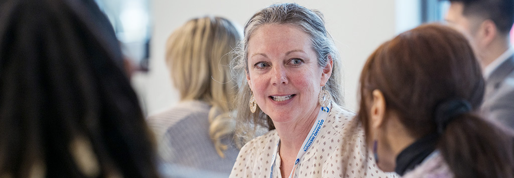 A close-up shot of a woman in conversation with a student