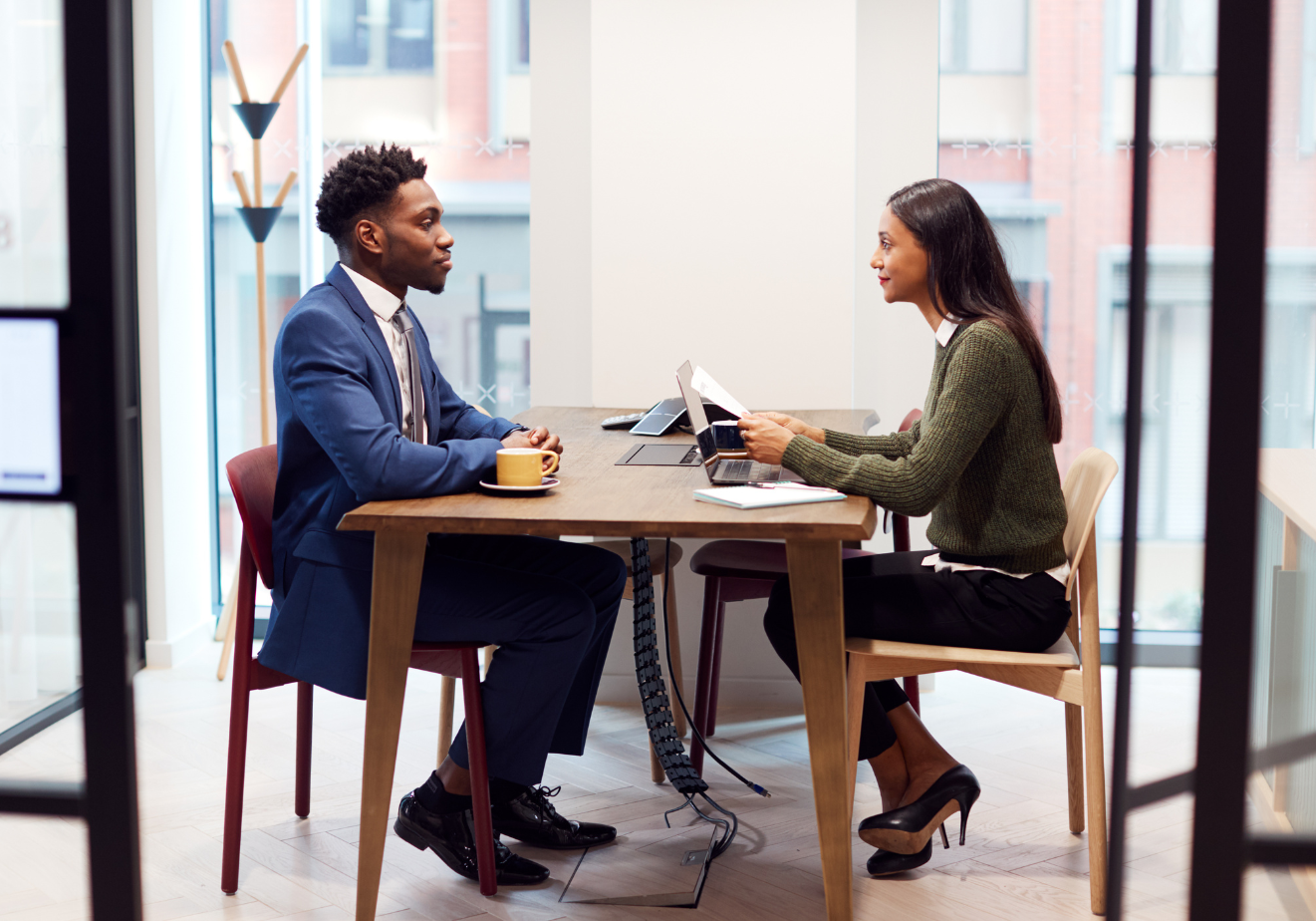 Man and woman sitting down at a job interview