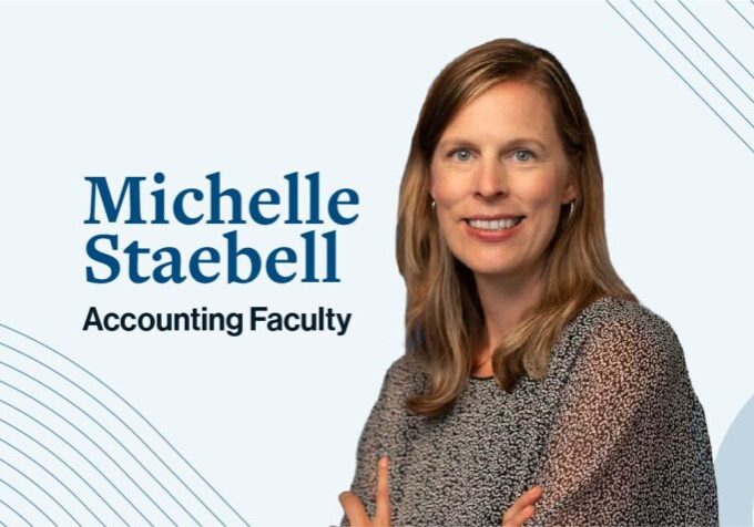 Photo of accounting faculty Michelle Stabell smiling with arms crossed.